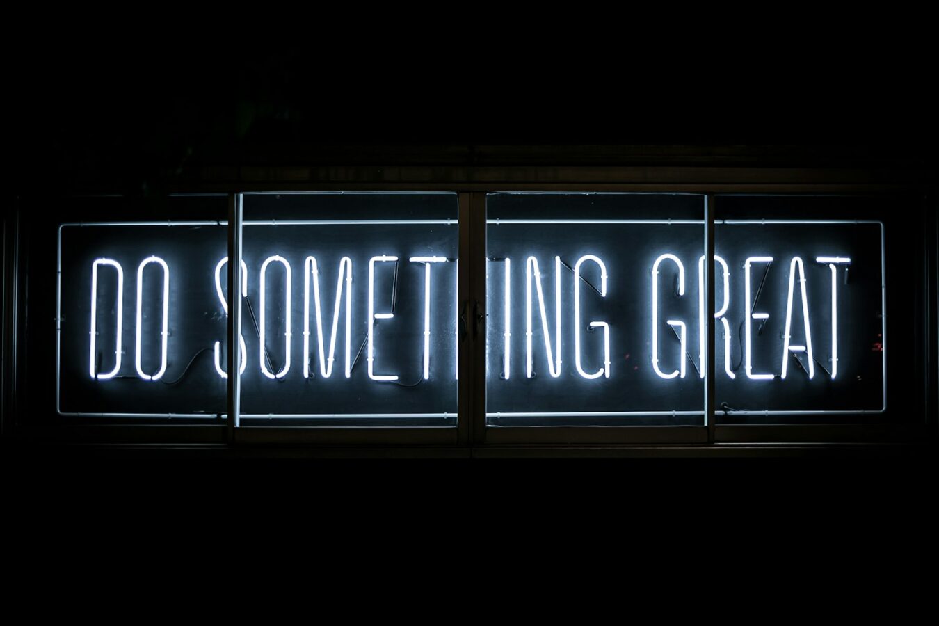 Neon sign reading Do Something Great, representing 25 things you can ask Claude to do in WordPress