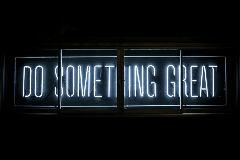 Neon sign reading Do Something Great, representing 25 things you can ask Claude to do in WordPress