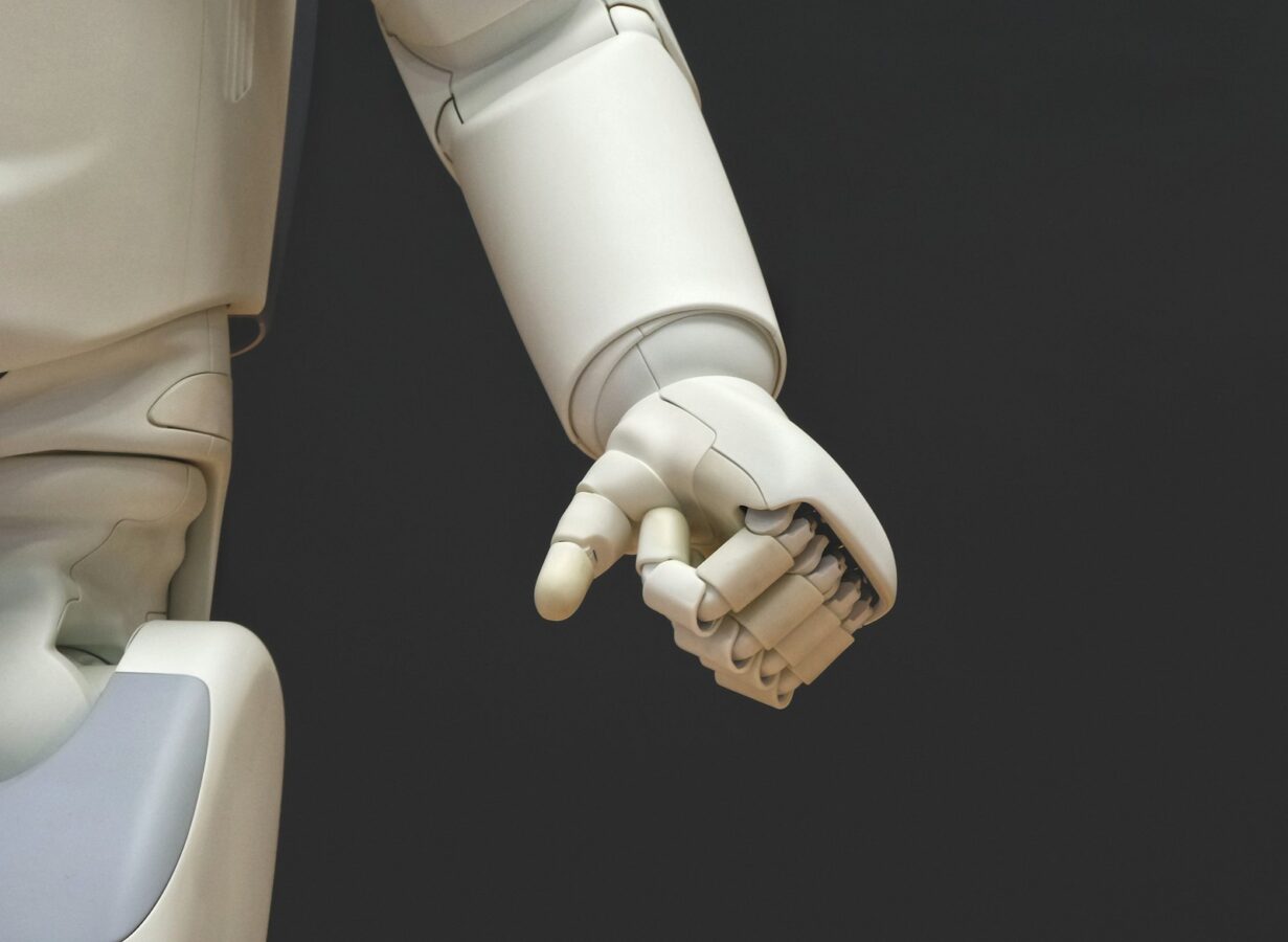 White humanoid robot hand, representing AI agents connected to WooCommerce